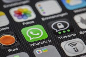 Detailed macro of smartphone screen showcasing popular app icons like WhatsApp.